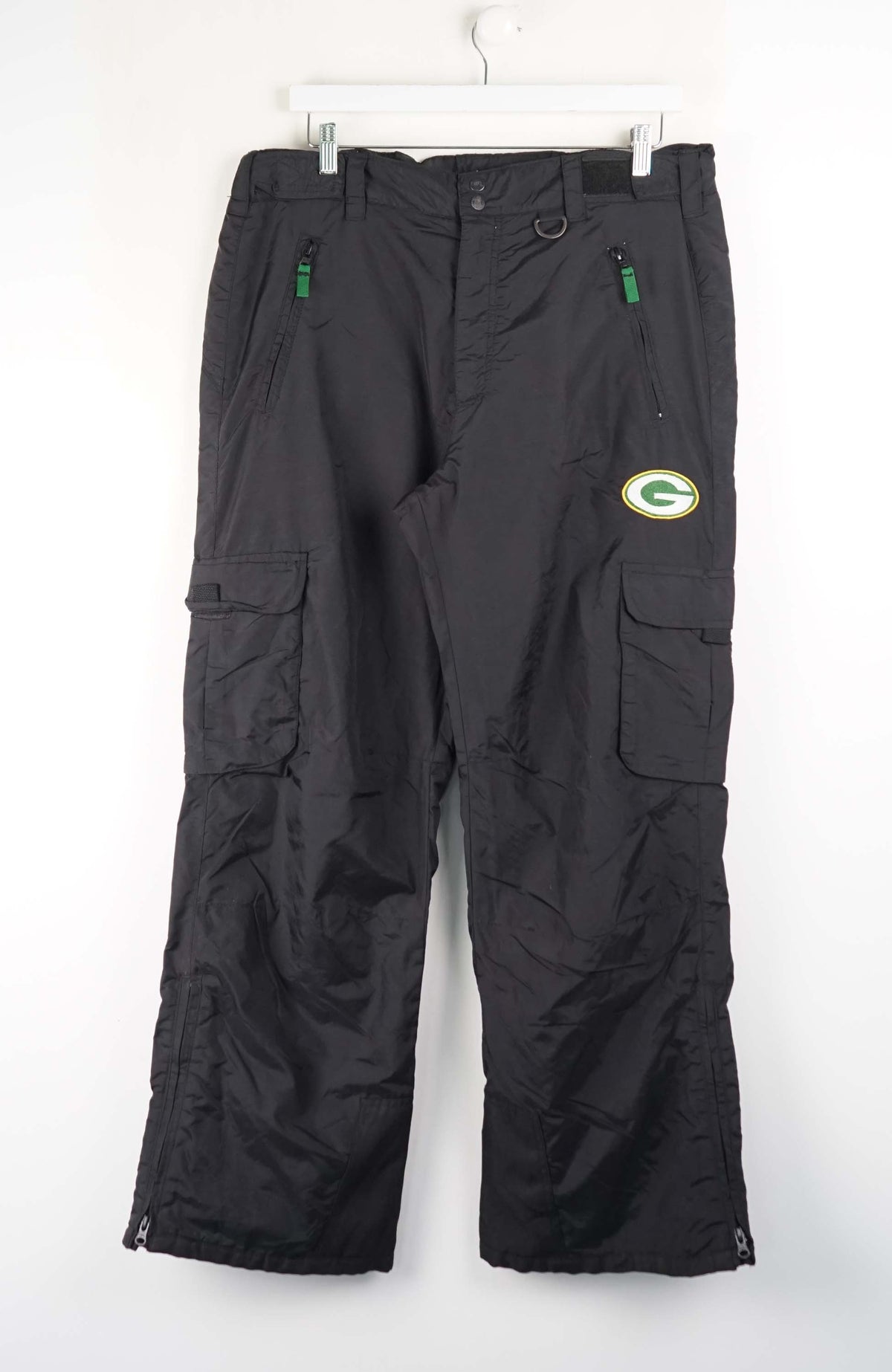 Black cargo pants with a logo on a white background