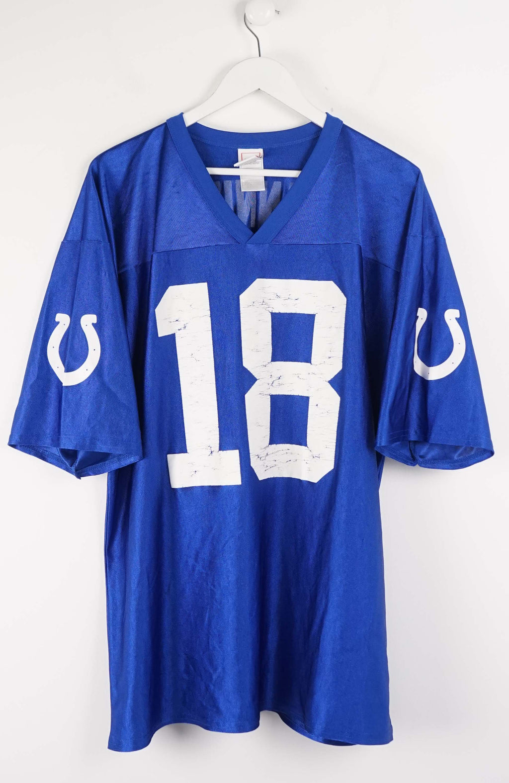 Blue sports jersey with number 18 and team logo on a white background