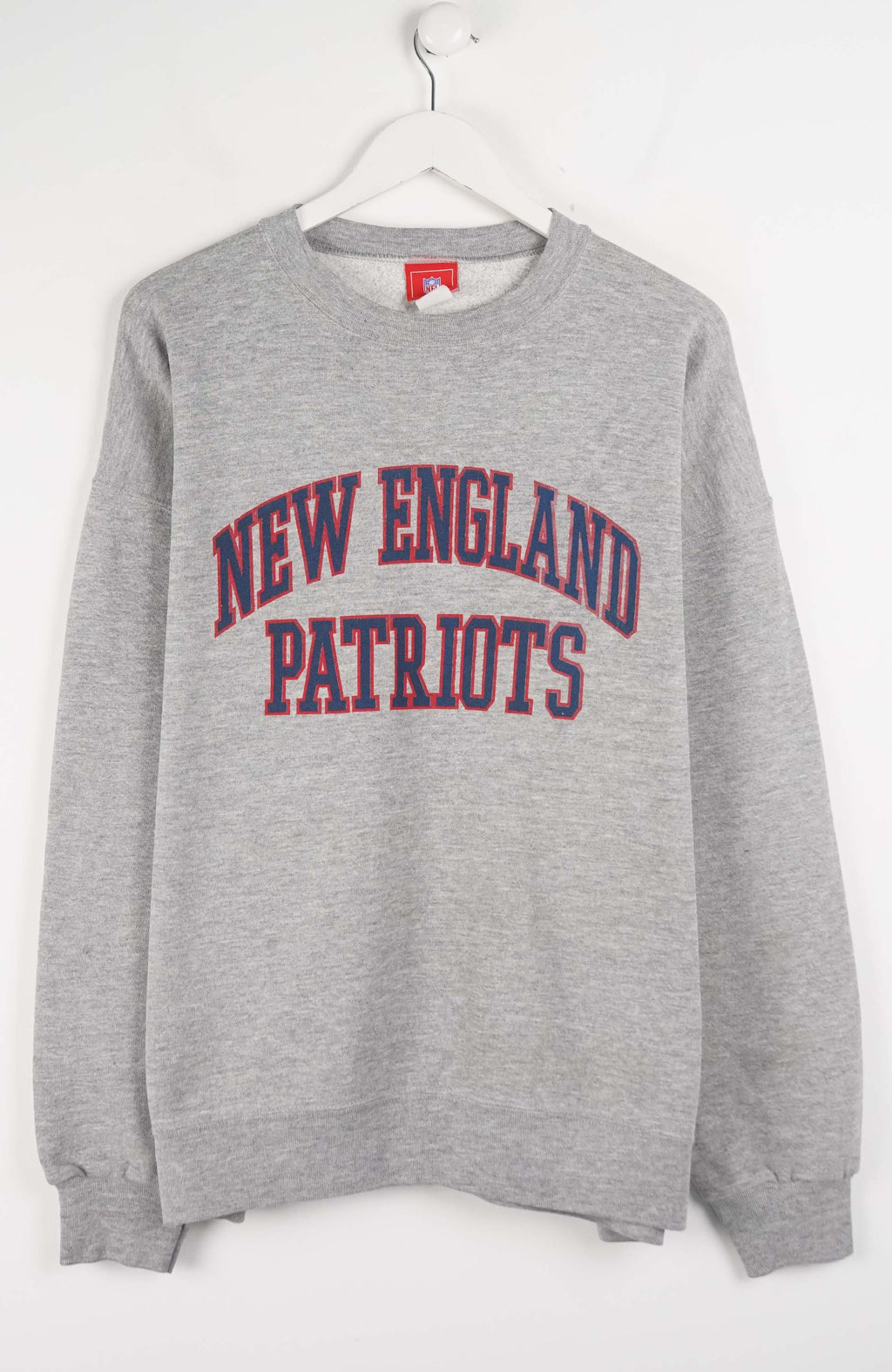 Gray sweatshirt with 'New England Patriots' text on a white background