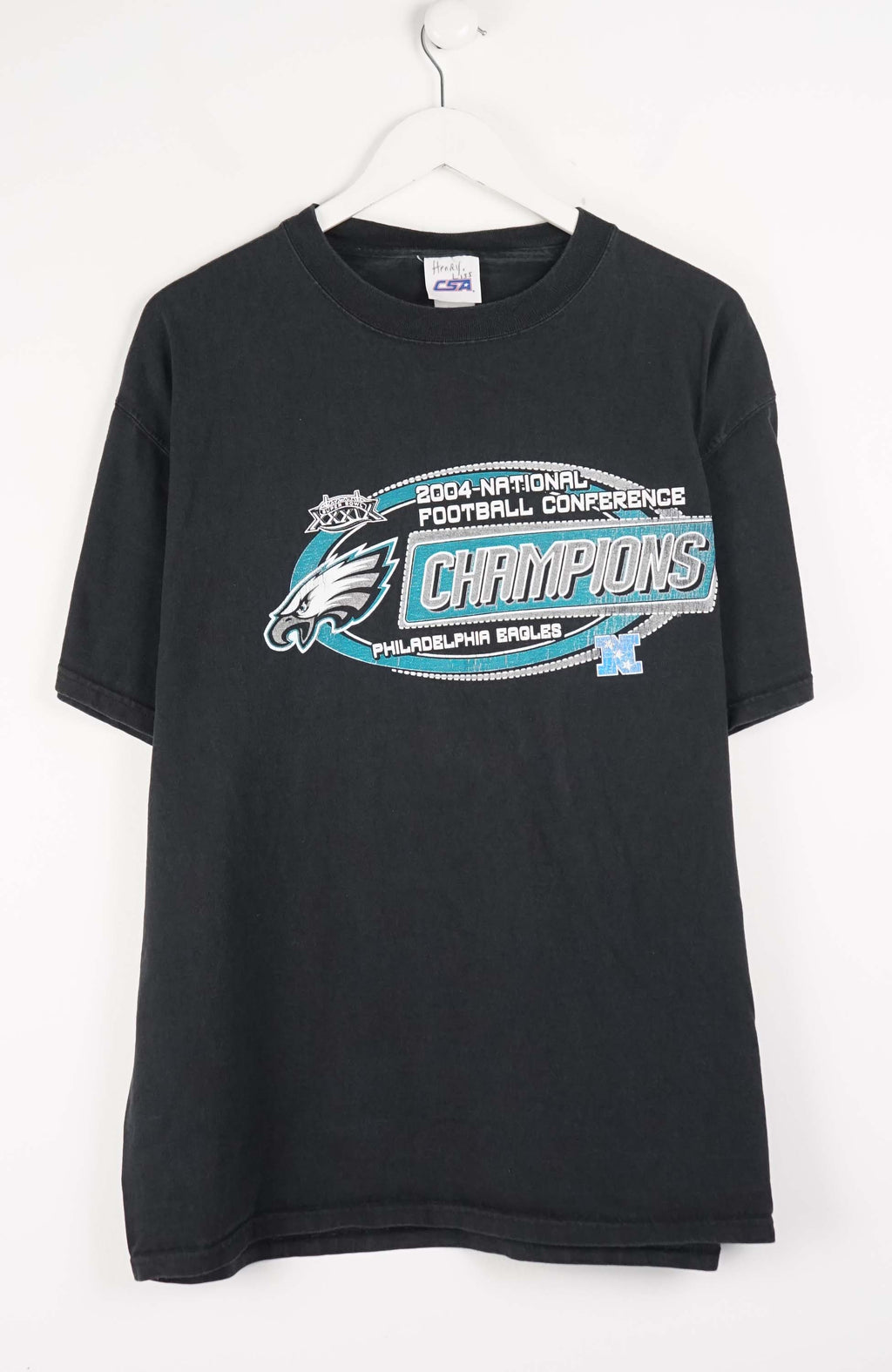 Black t-shirt with sports team logo and text on a white background