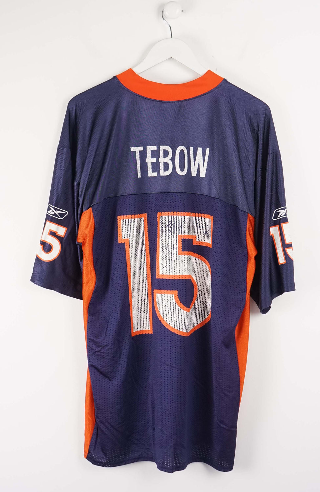 Navy and orange sports jersey with number 15 on a white background