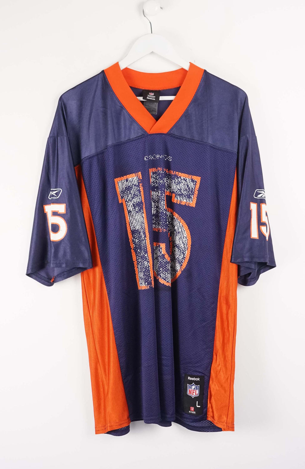 Navy and orange sports jersey with number 15 on a white background