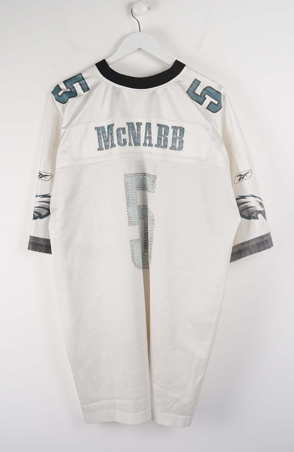 White sports jersey with number 5 and team logo on a white background