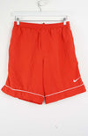 Red shorts with a Nike logo on a white background