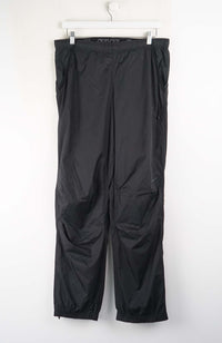 Black pants hanging on a white background
