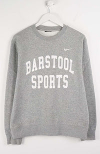 Gray sweatshirt with 'Barstool Sports' text and Nike logo on a white background