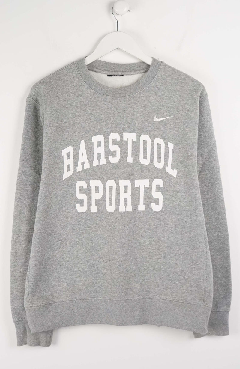 Gray sweatshirt with 'Barstool Sports' text and Nike logo on a white background