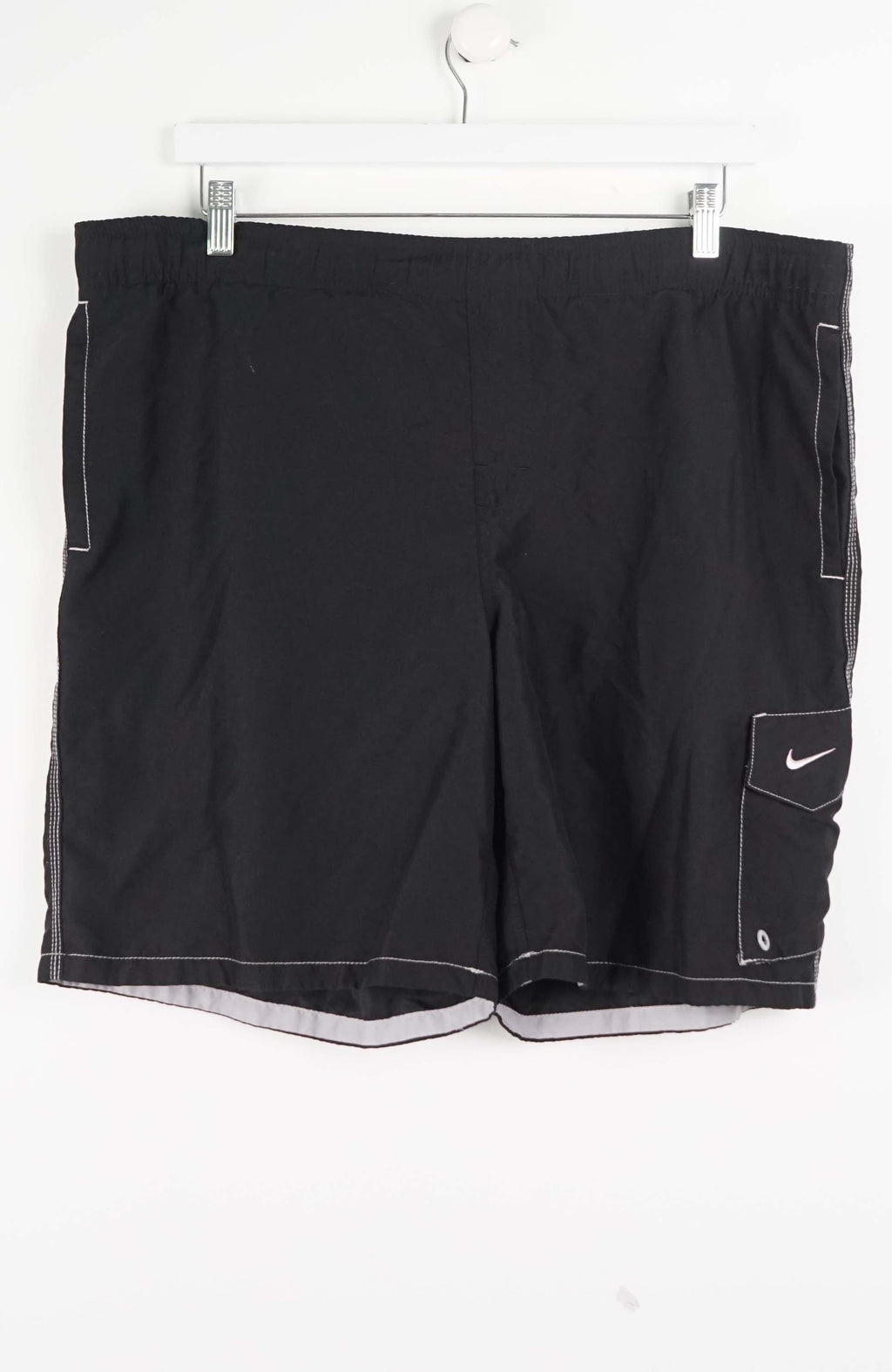 Black shorts with a Nike logo on a white background