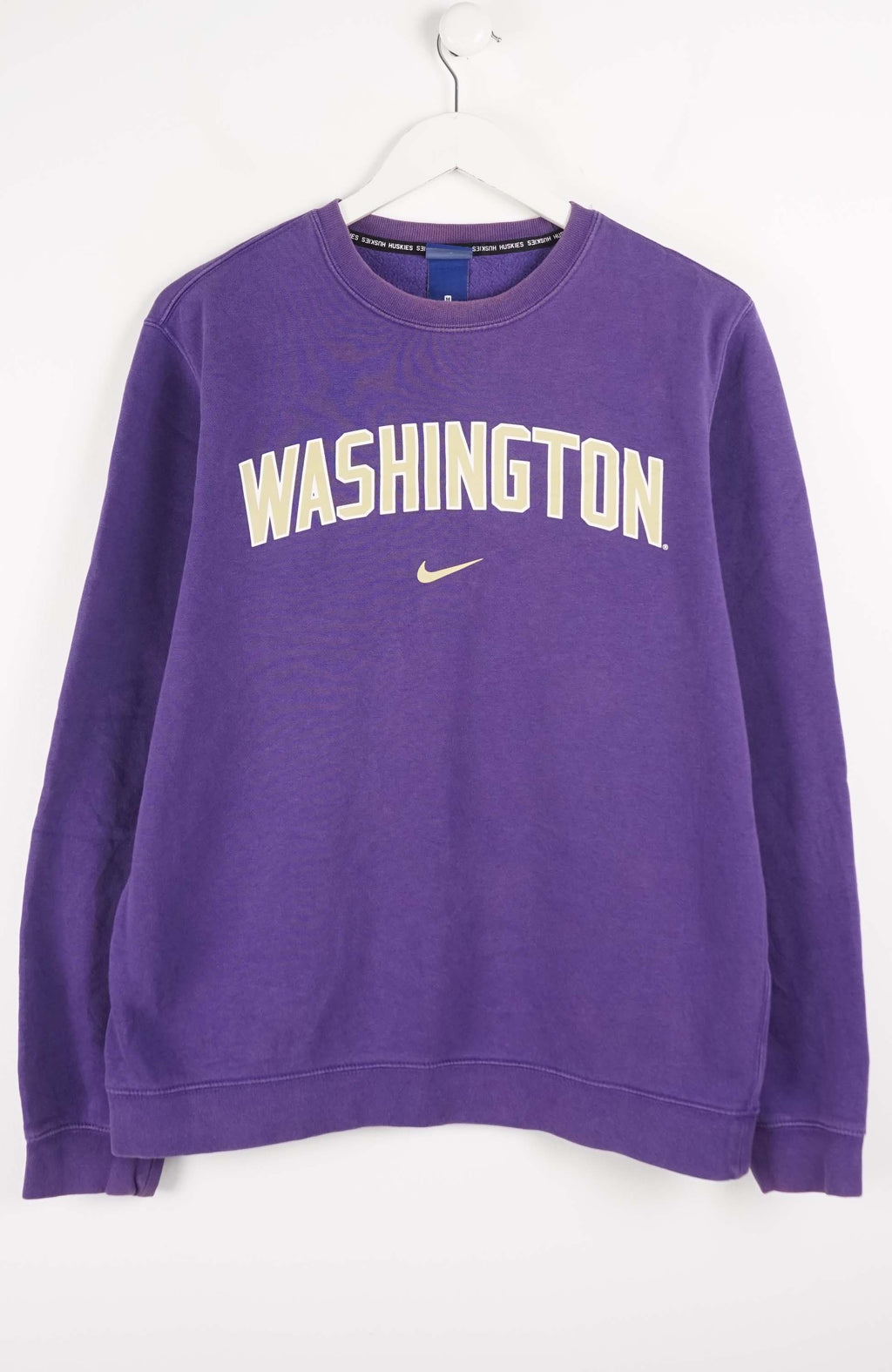 Purple sweatshirt with 'Washington' and Nike logo on a white background