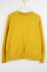 Yellow sweatshirt with a Nike logo on a white hanger against a white background