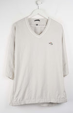 Beige V-neck shirt with a small logo on a white background