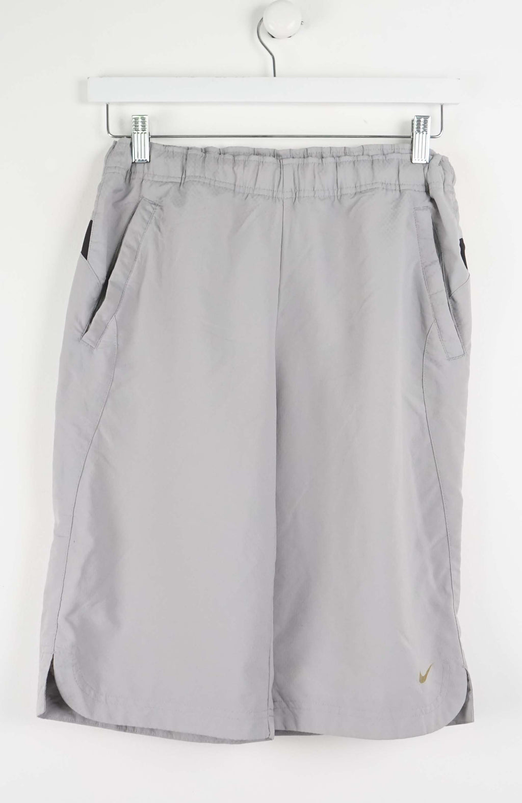 Gray shorts with a Nike logo on a white background