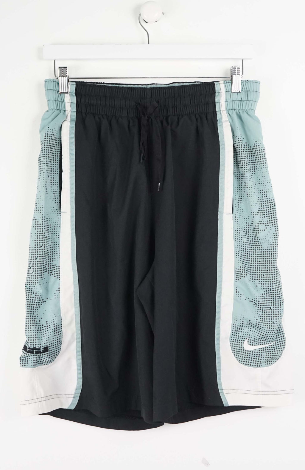Black athletic pants with mesh side panels on a white hanger