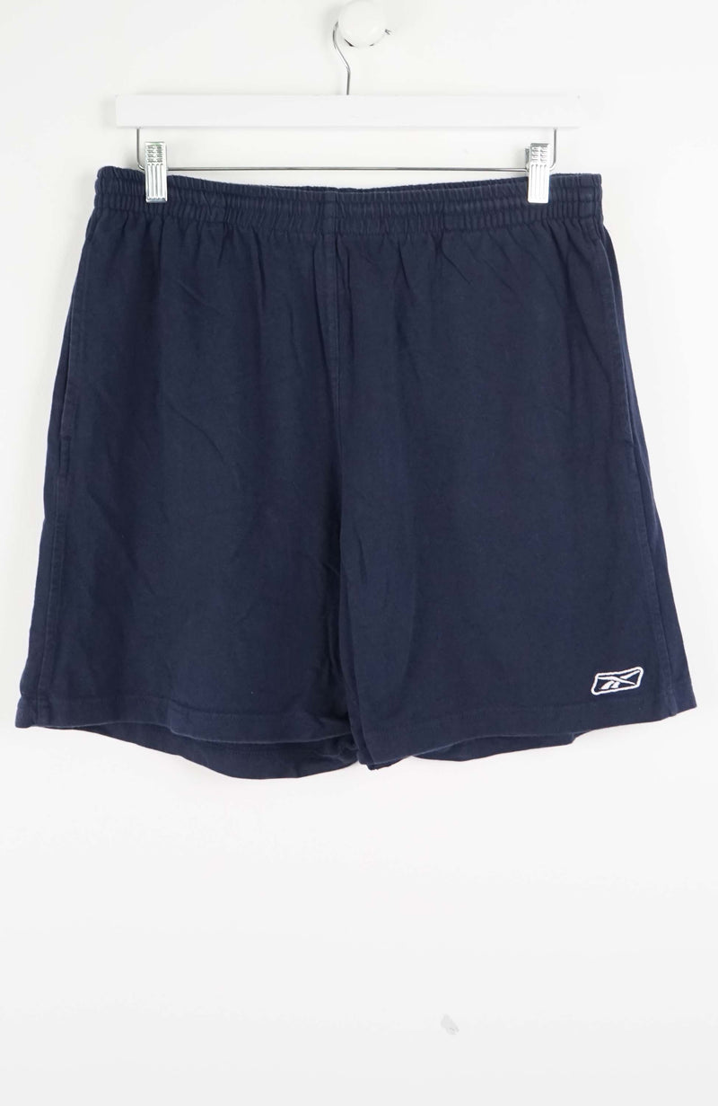 Navy blue shorts with a brand logo on a white background