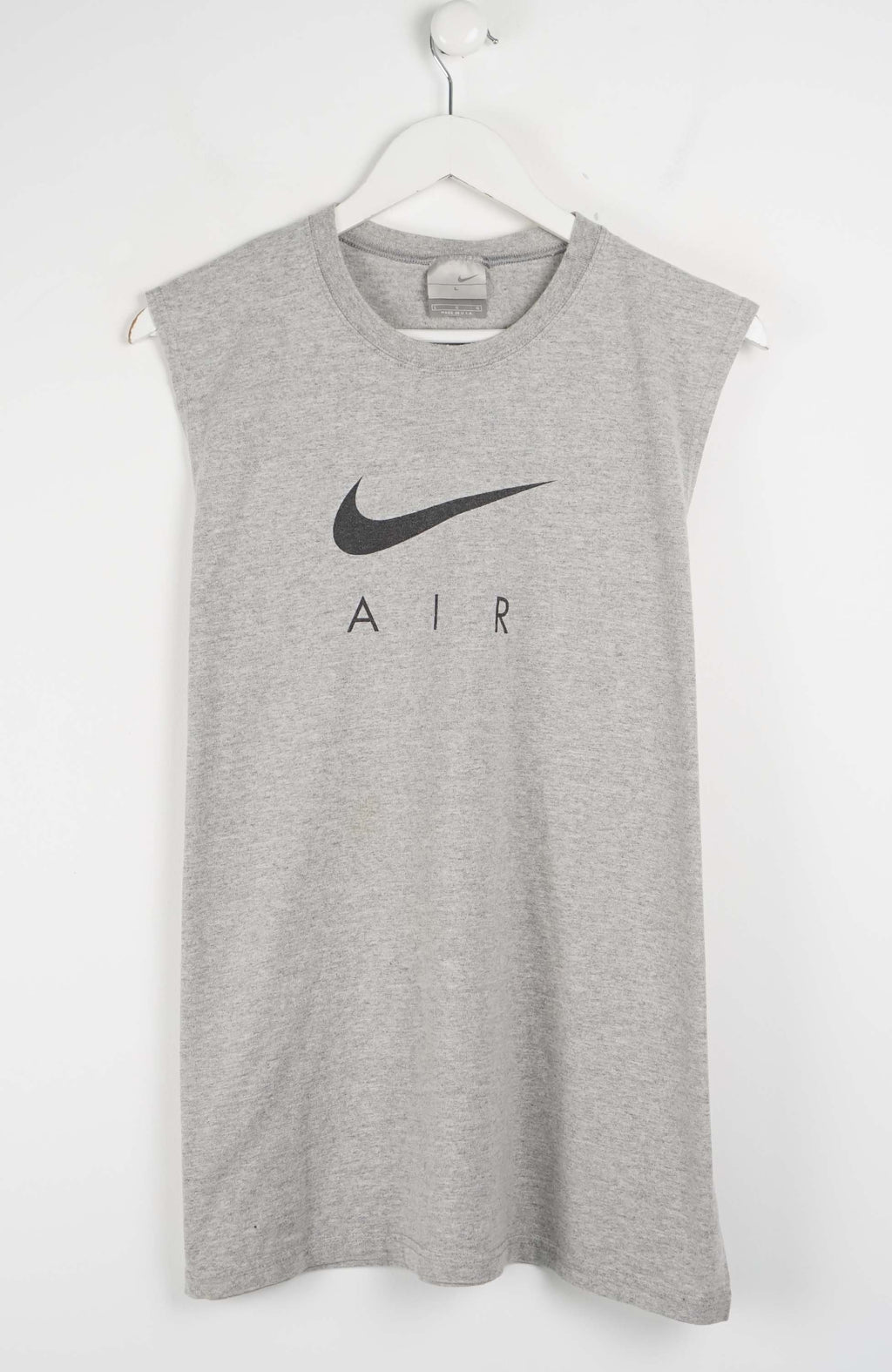 Gray sleeveless Nike shirt with black logo on a white background