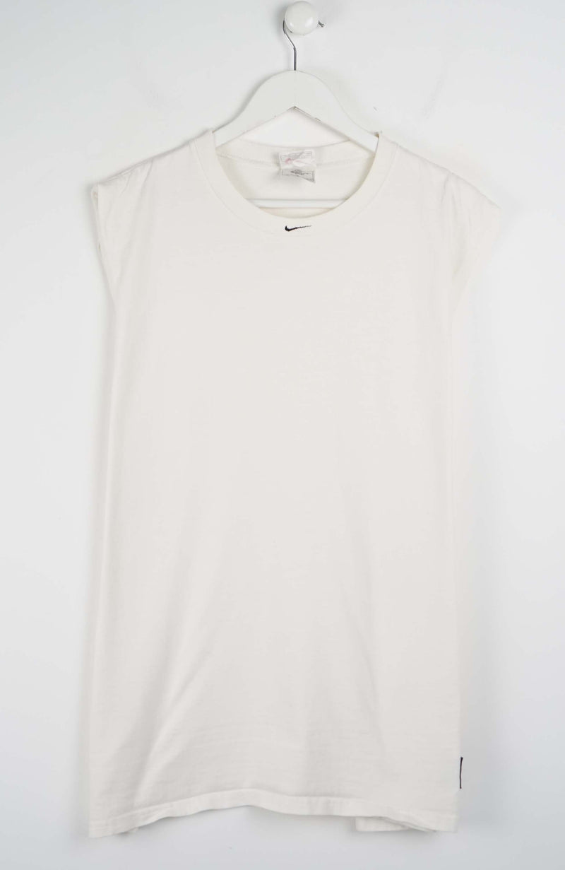 White sleeveless shirt on a hanger against a white background