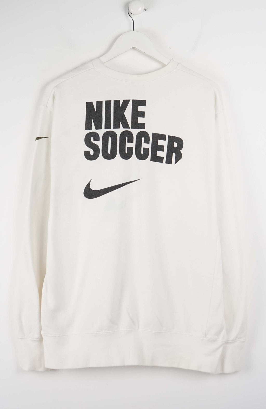 White sweatshirt with Nike logo on a hanger against a white background