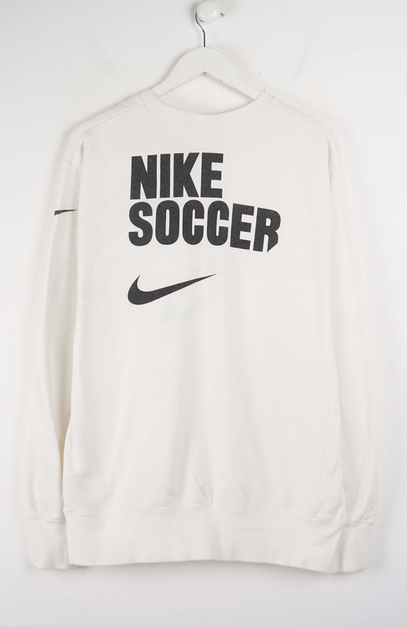 White sweatshirt with 'Nike Soccer' text and logo on a white background