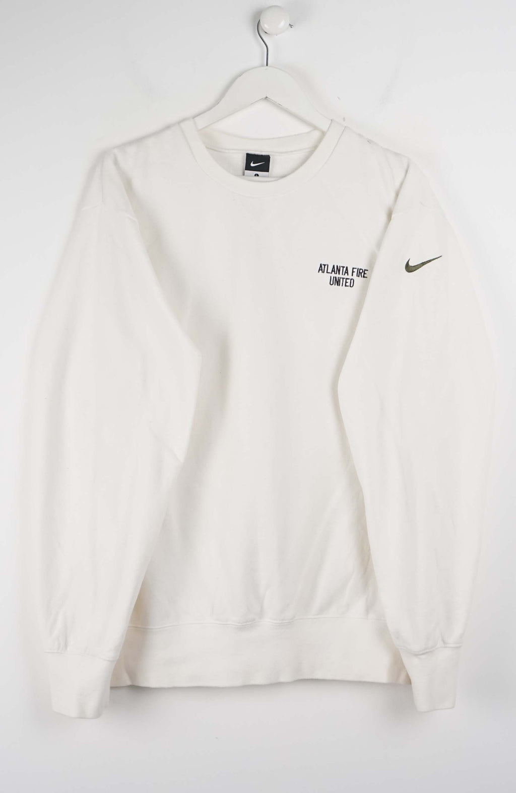 White sweatshirt with Nike logo on a hanger against a white background