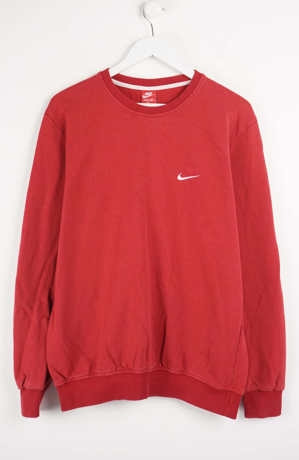 Red sweatshirt with Nike logo on a white background