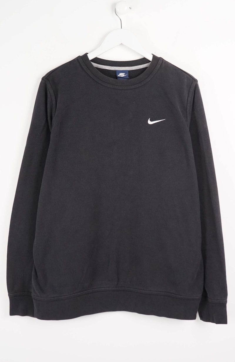 Black Nike sweatshirt on a white hanger against a white background