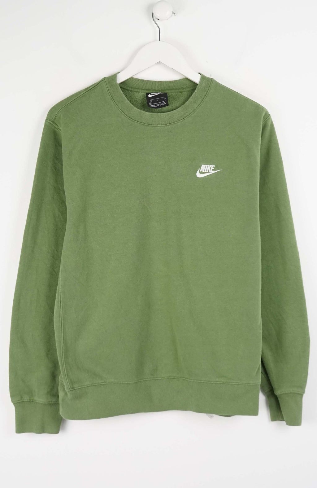 Green Nike sweatshirt on a white hanger against a white background
