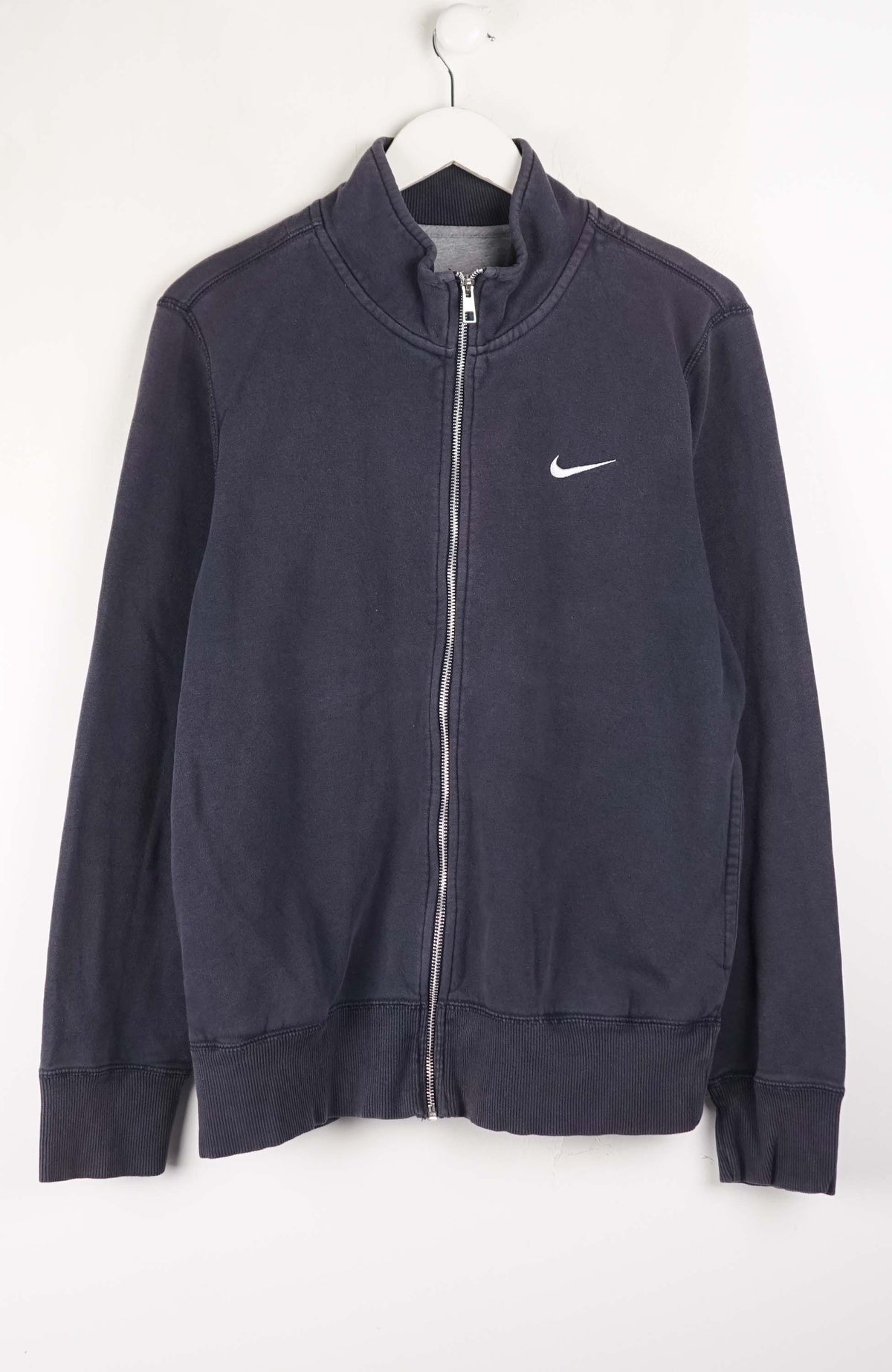 Navy blue jacket with a Nike logo on a white background
