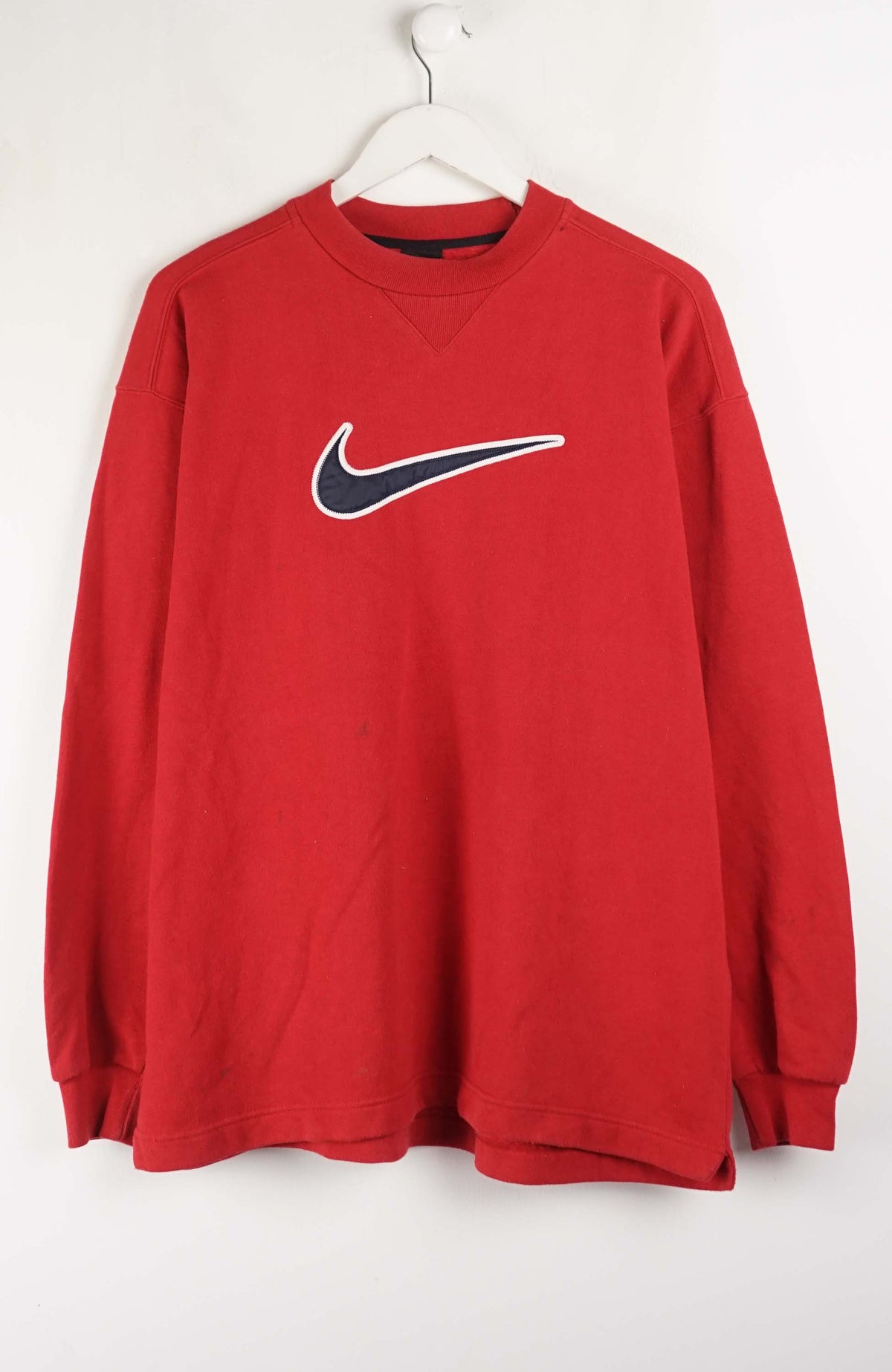 Red sweatshirt with a Nike logo on a white background