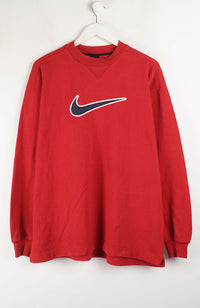 Red sweatshirt with a Nike logo on a white background