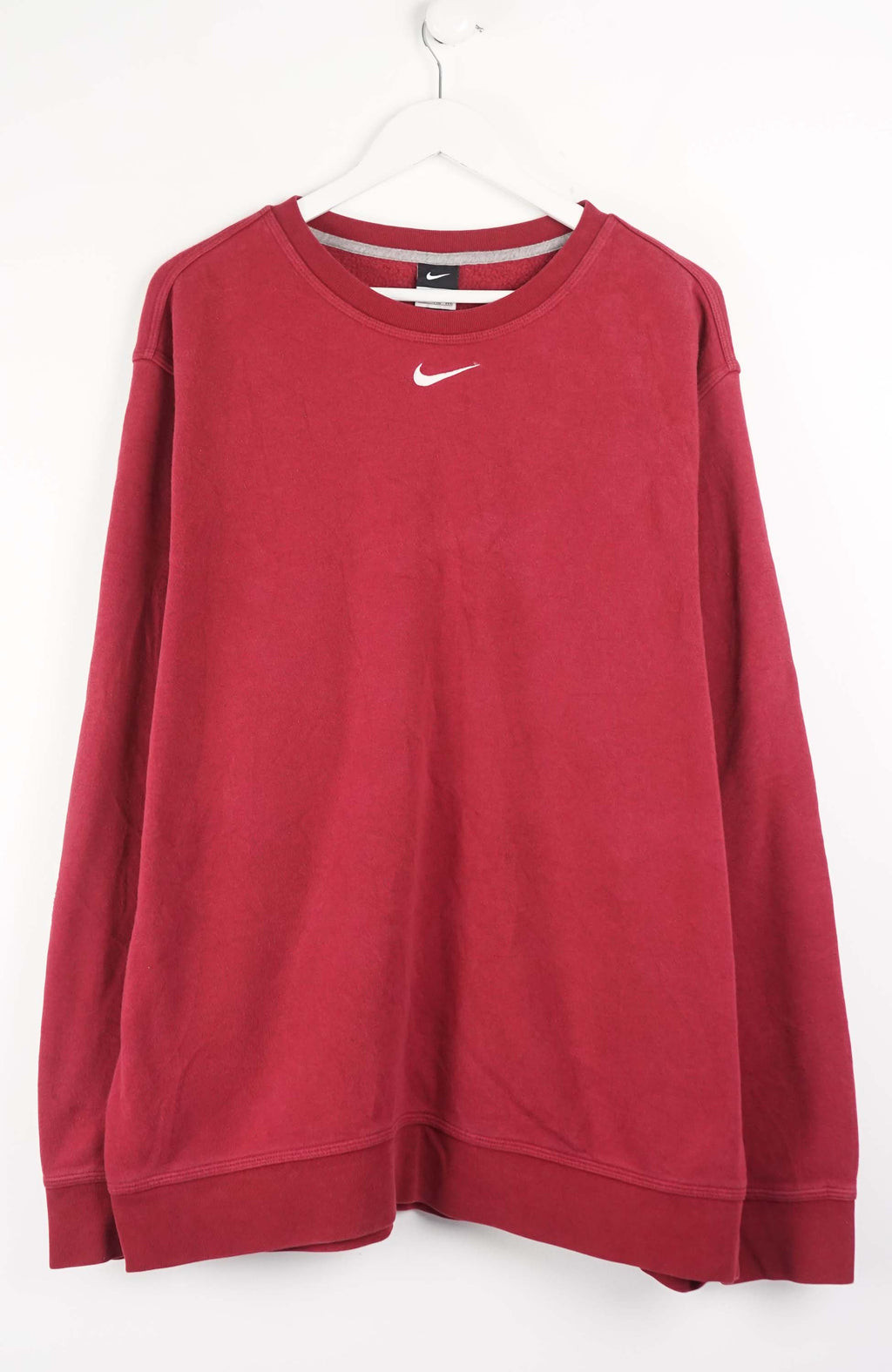 Red sweatshirt with Nike logo on a white background
