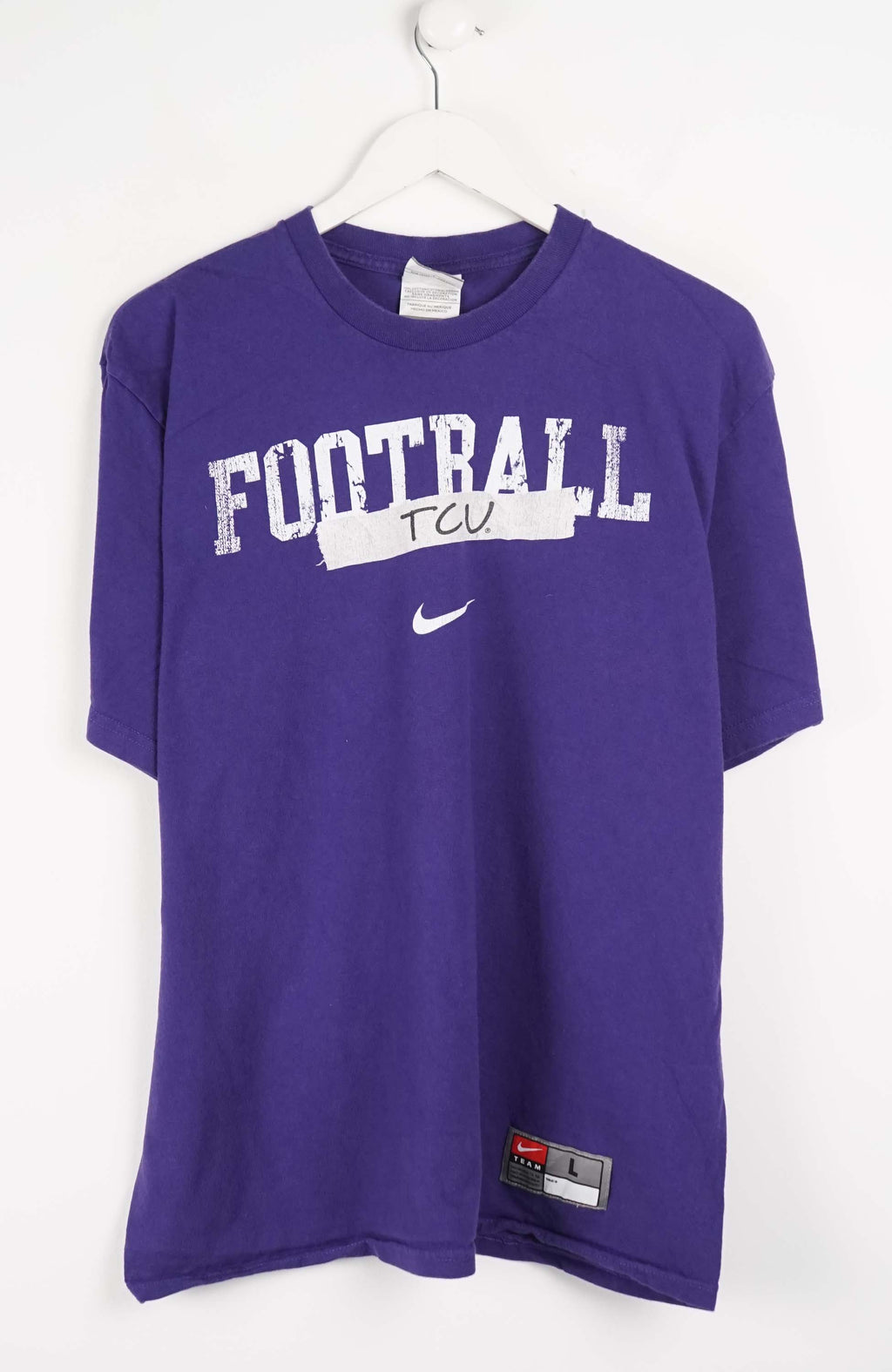 Purple t-shirt with 'FOOTBALL TCU' text and Nike logo on a white background