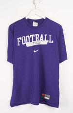 Purple t-shirt with 'FOOTBALL TCU' text and Nike logo on a white background