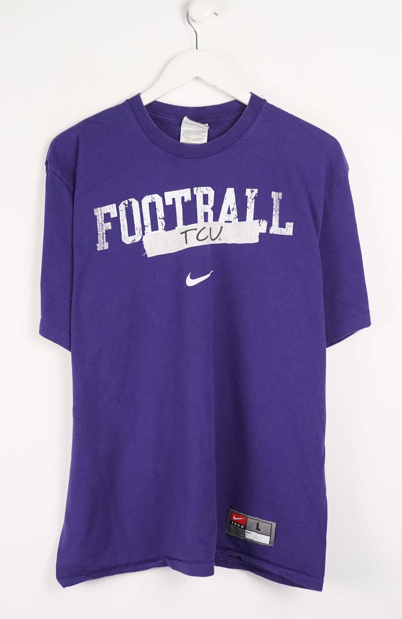 Purple t-shirt with 'FOOTBALL TCU' text and Nike logo on a white background