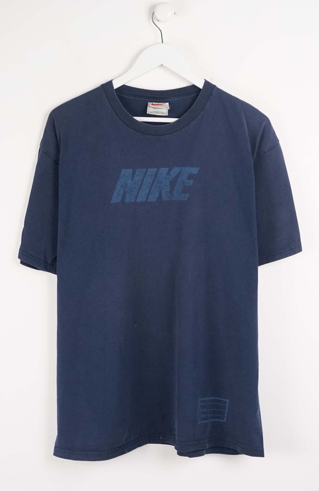 Navy blue t-shirt with Nike logo on a white background
