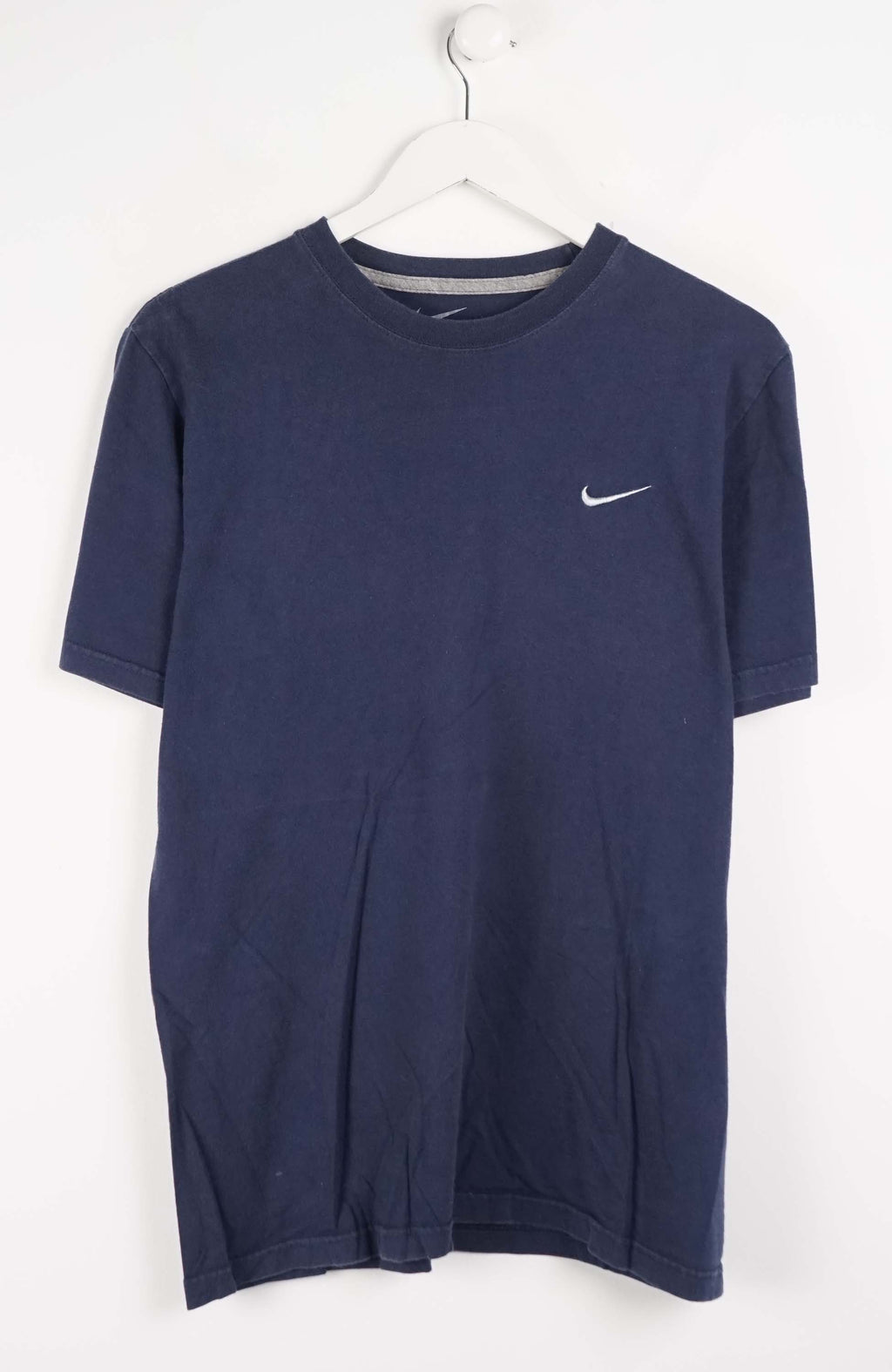 Navy blue t-shirt with a small white logo on a white background