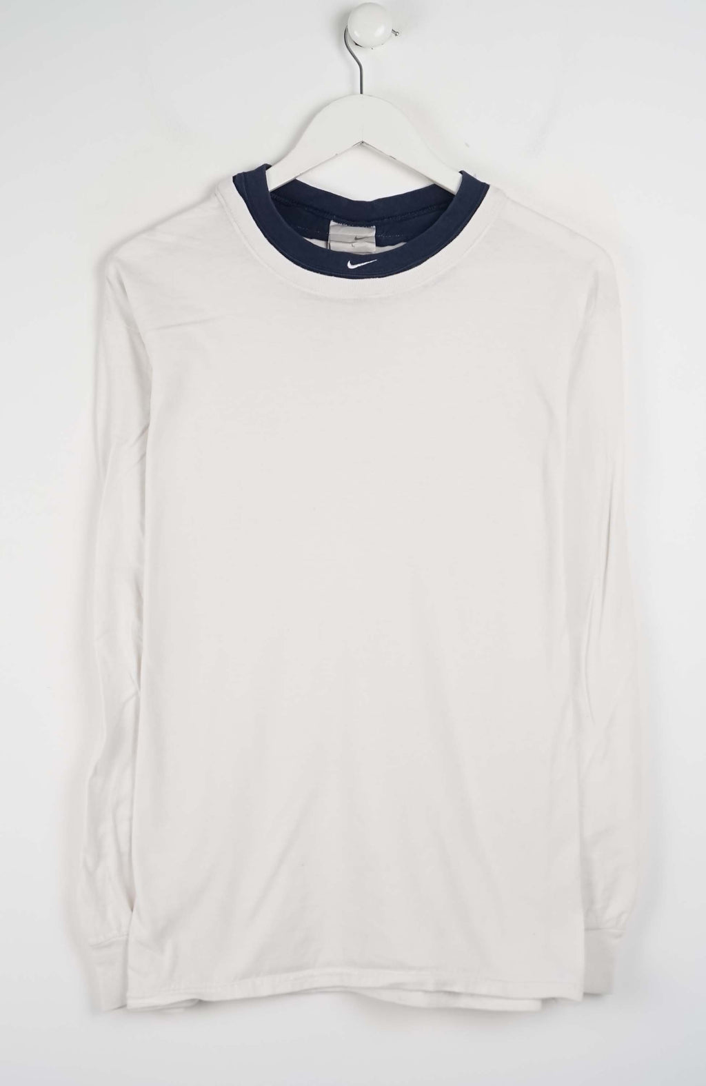 White long-sleeve shirt with navy collar on a white hanger against a white background