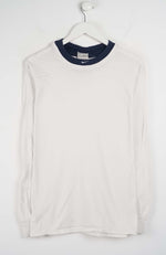 White long-sleeve shirt with navy collar on a white hanger against a white background