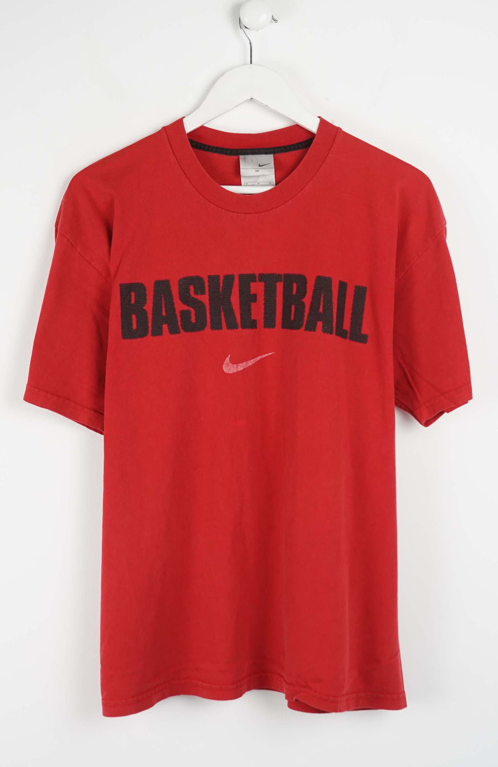 Red t-shirt with 'Basketball' text and Nike logo on a white background