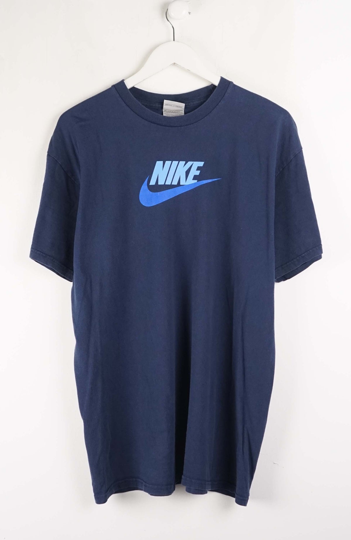 Blue t-shirt with Nike logo on a white hanger