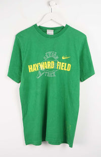 Green t-shirt with 'Hayward Field' text on a white background