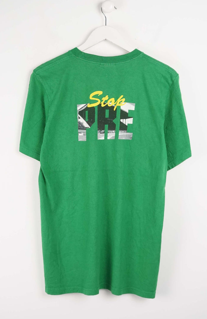 Green t-shirt with 'Stop Pre' text on a white background