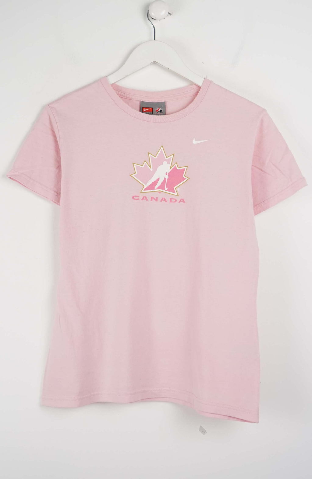 Pink t-shirt with a logo and 'Canada' text on a white background