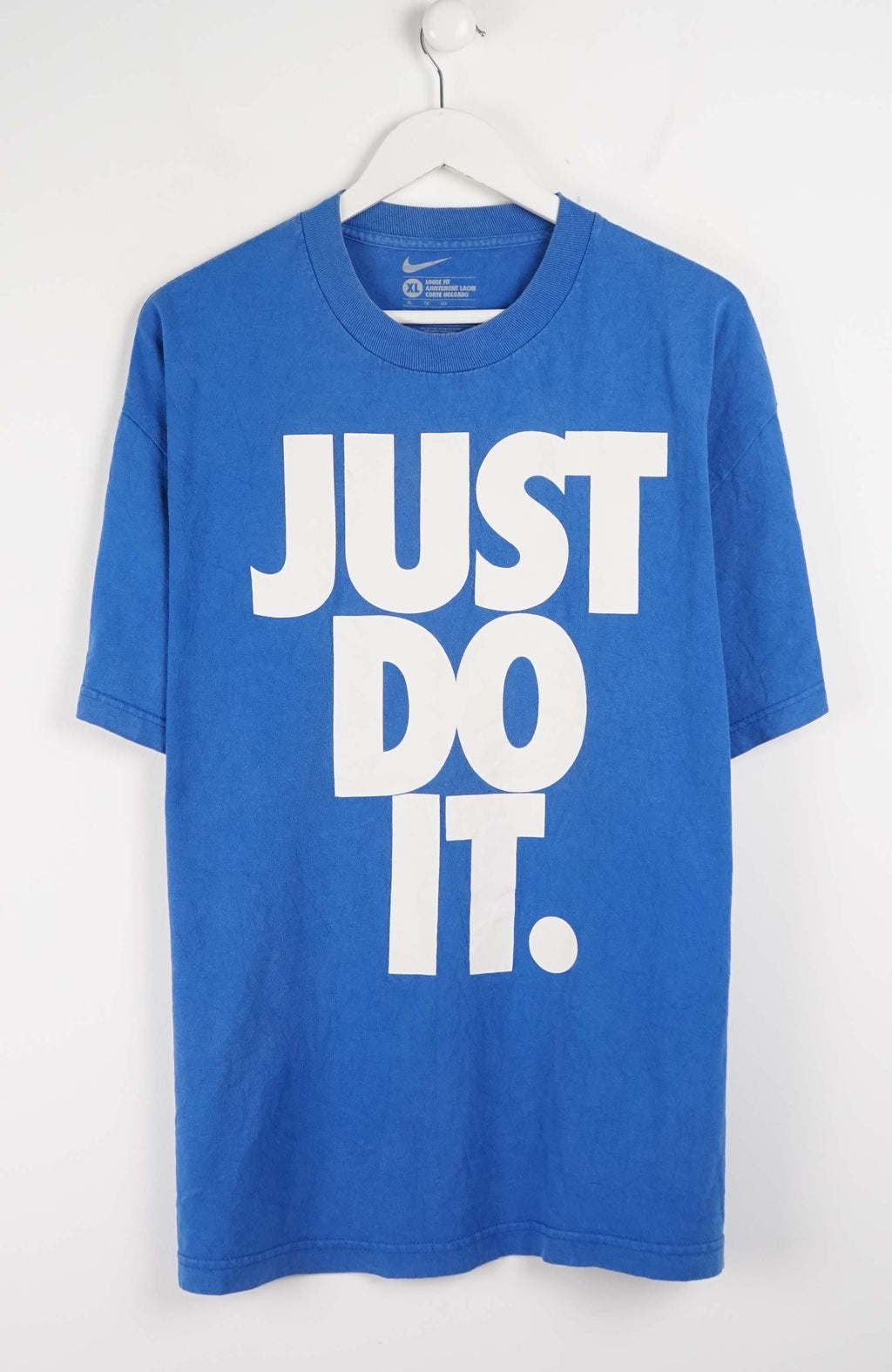Blue t-shirt with 'JUST DO IT.' text on a white background