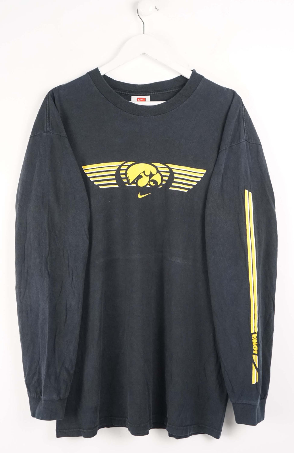 Black long-sleeve shirt with yellow graphics on a white background