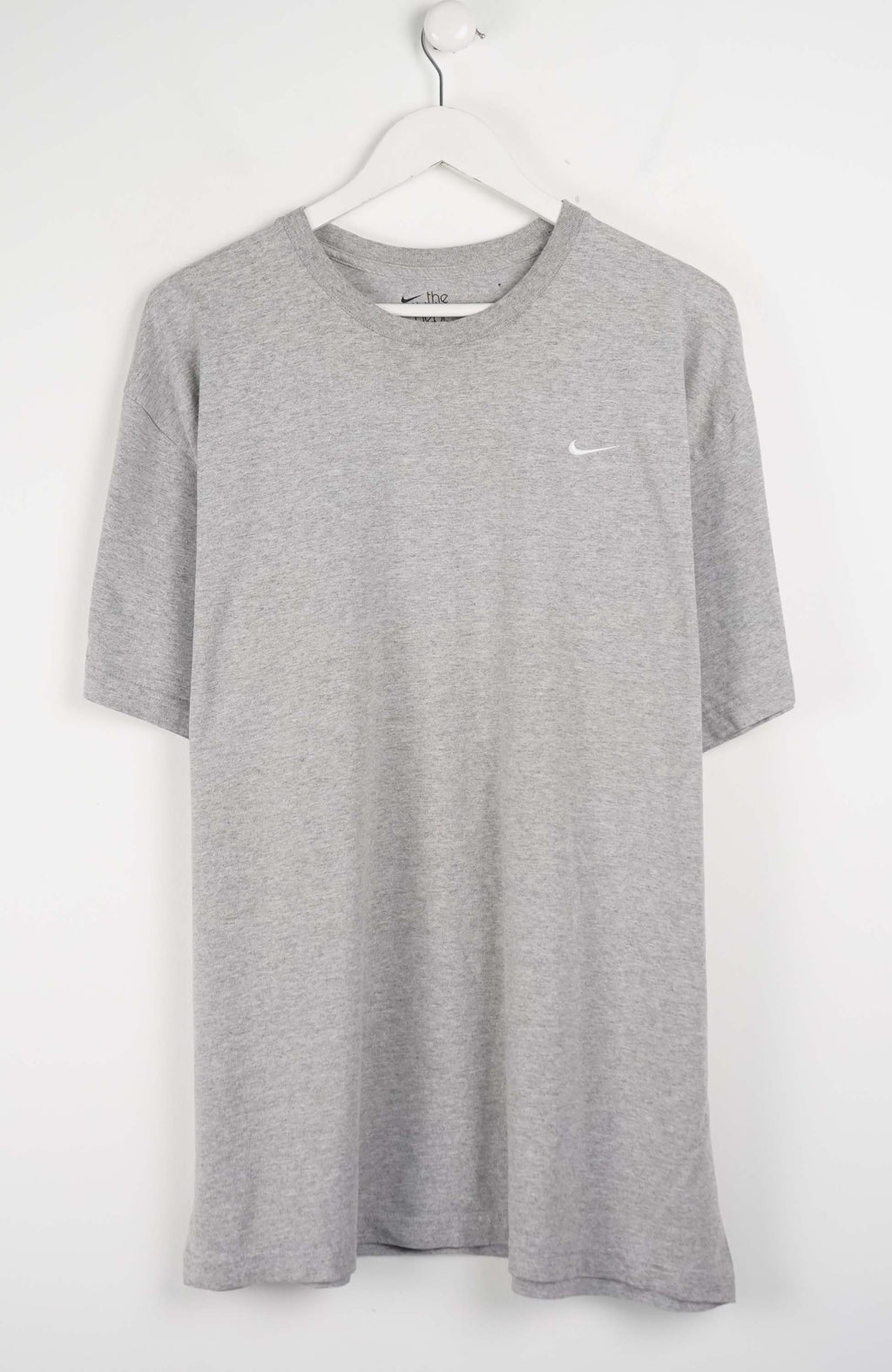 Gray t-shirt with a small NIKE logo on a white background