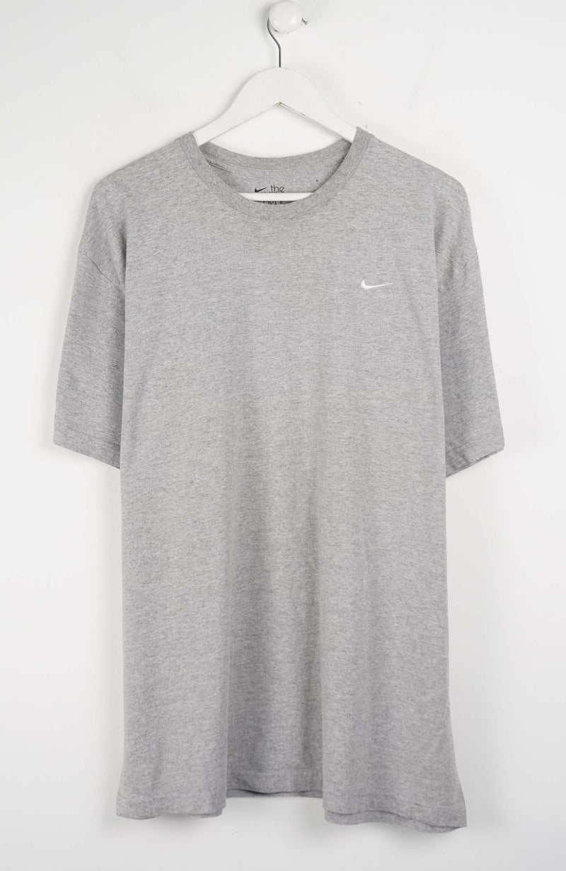 Gray t-shirt with a small NIKE logo on a white background