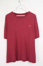 Red t-shirt with a Nike logo on a white hanger