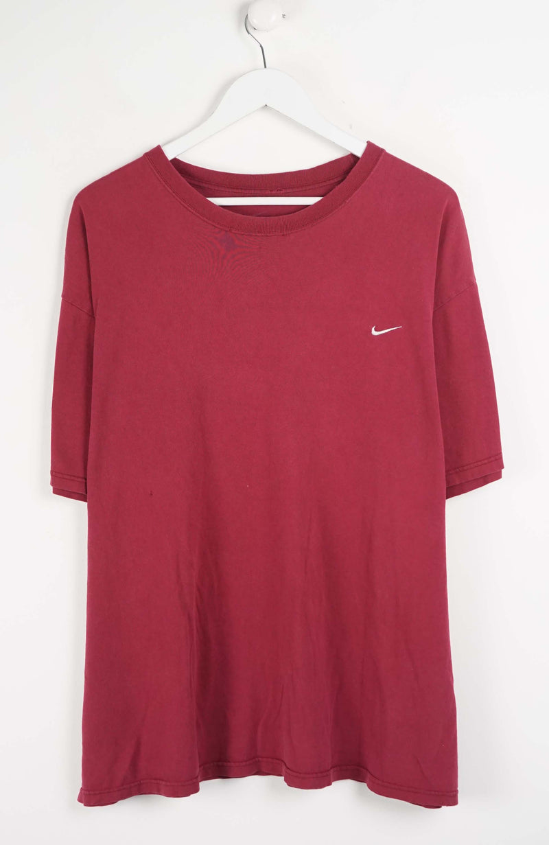 Red t-shirt with a Nike logo on a white hanger