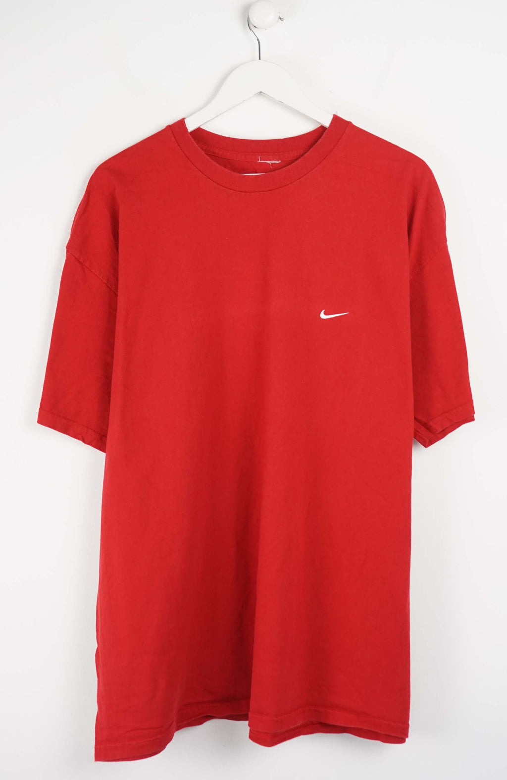Red t-shirt with a small logo on a white background