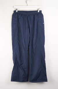 Navy blue pants with a Nike logo on a white background
